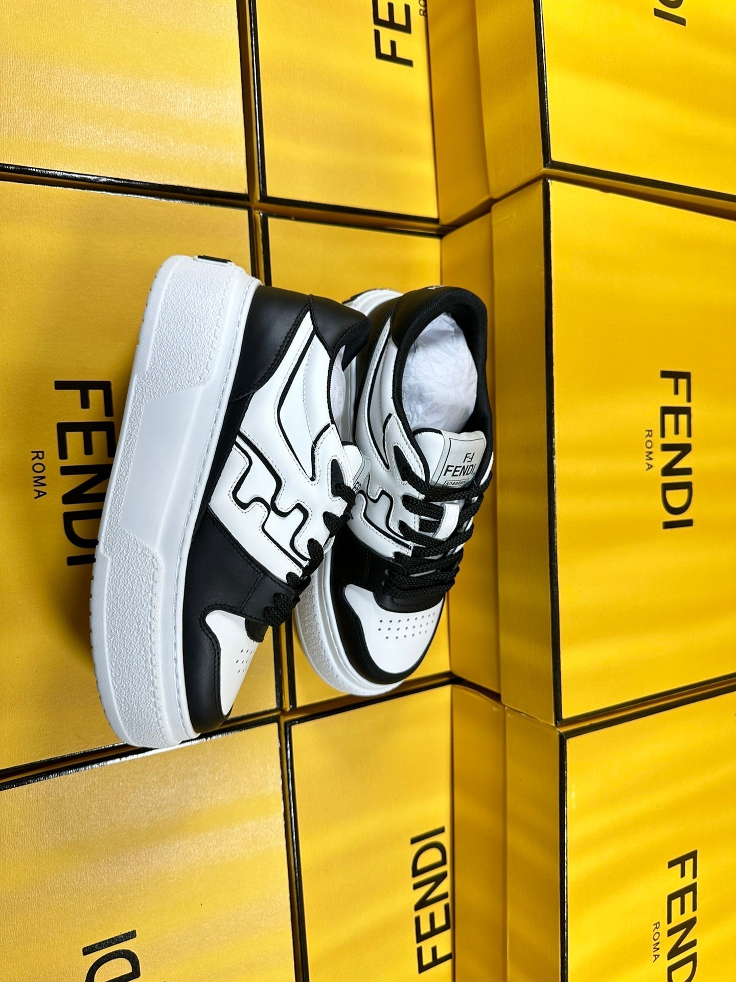 FENDI THICK-SOLDED SNEAKER IN WHITE AND BLACK LAMBSKIN