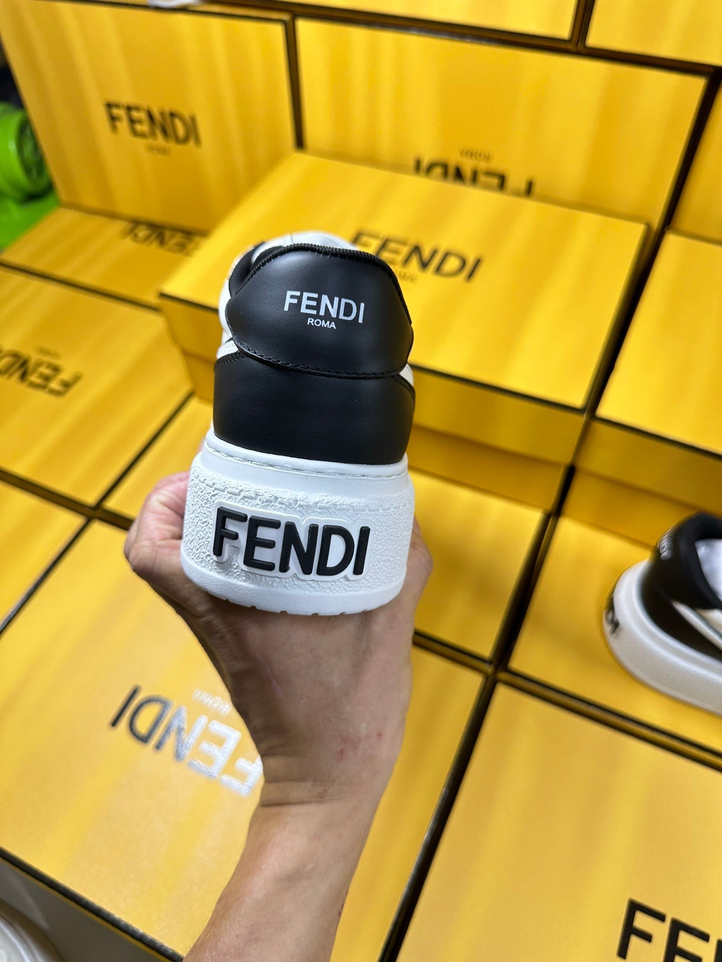 FENDI THICK-SOLDED SNEAKER IN WHITE AND BLACK LAMBSKIN