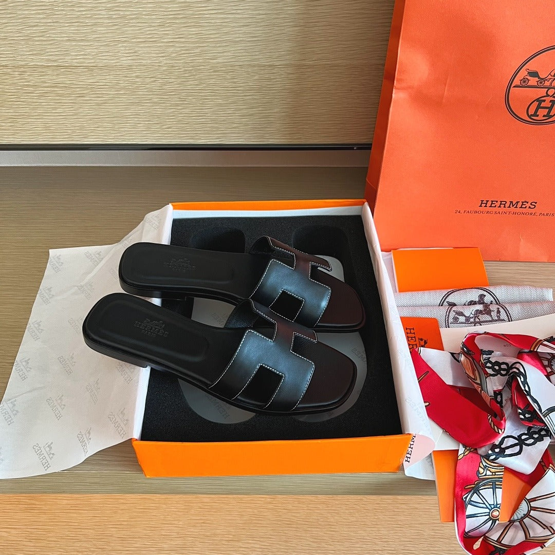 Hermès Oran Sandals in Black Leather with White Contrast Stitching
